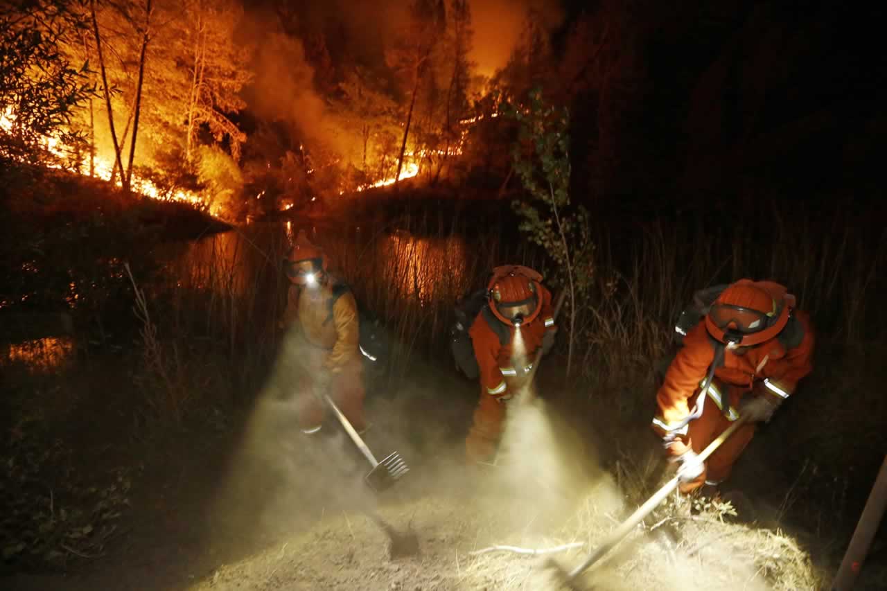 Firefighters create a firebreak near a home in Middletown, Calif., on Sunday, Sept. 13, 2015. <span class=meta>AP Photo/Elaine Thompson</span>