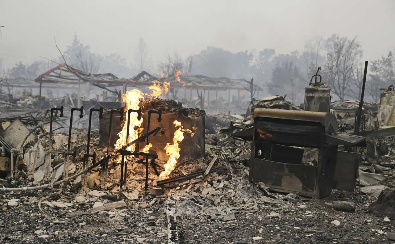 Flames continue to burn near gas lines at a destroyed apartment complex Sunday, Sept. 13, 2015, in Middletown , Calif. <span class=meta>AP Photo/Eric Risberg</span>