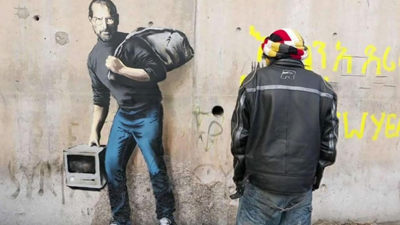 Two New Banksy Pieces Pop Up In York City Abc7news Com Banksy S Painting Of Steve Jobs Shines Positive Light On Accepting Refugees