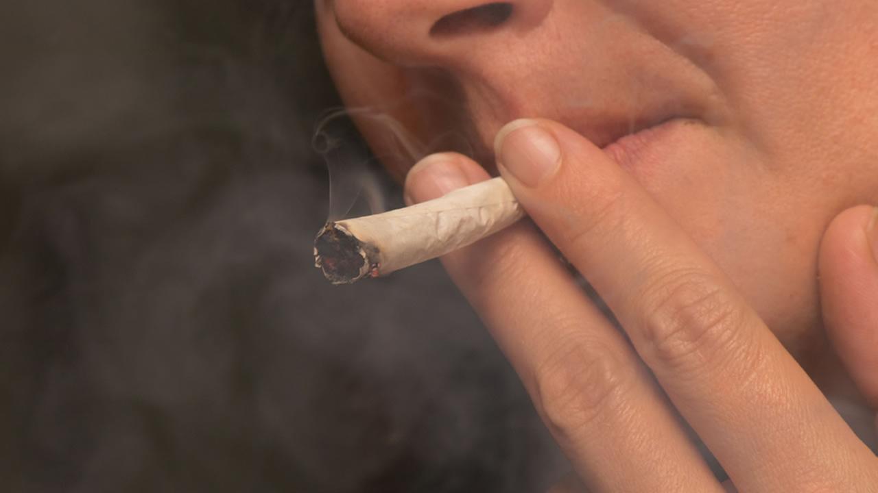 A woman smokes a marijuana joint in this undated file photo.