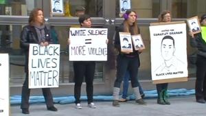 Anti-police brutality protesters shift tactics and block the Oakland Federal Building on Wednesday. 