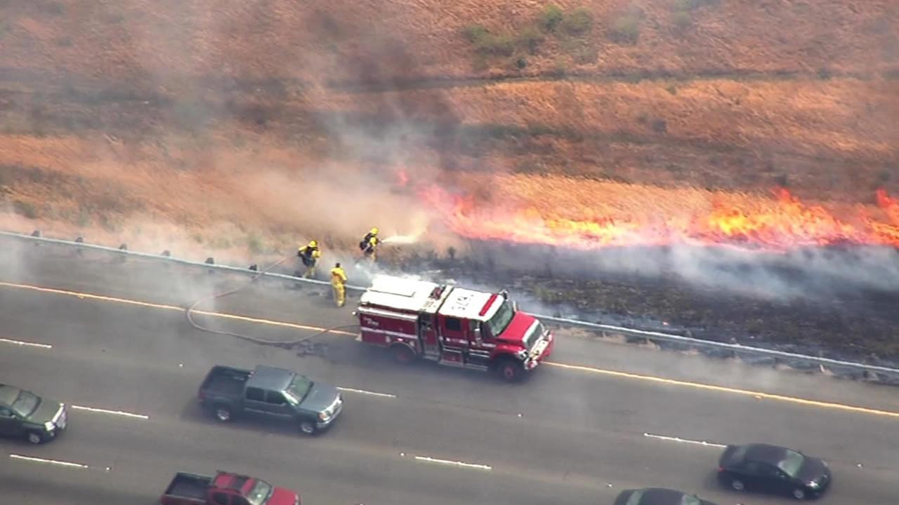 PHOTOS Crews contain brush fire along Interstate 580 in Altamont Pass