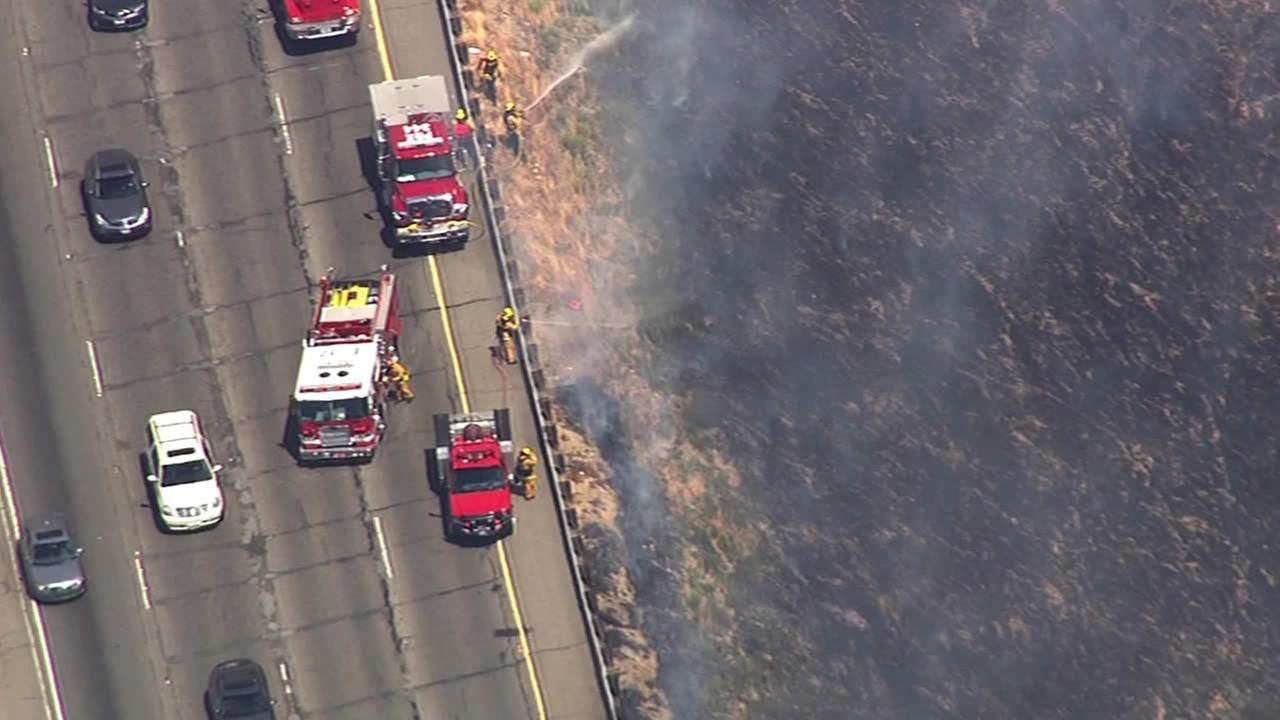 PHOTOS Crews contain brush fire along Interstate 580 in Altamont Pass
