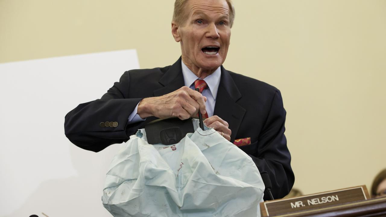 Senate Commerce Committee member Sen. Bill Nelson, D-Fla. displays the parts and function of a defective airbag made by Takata of Japan on Nov. 20, 2014. (AP Photo)