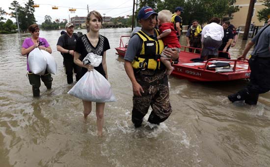 <div class='meta'><div class='origin-logo' data-origin='AP'></div><span class='caption-text' data-credit='AP Photo/David J. Phillip'>Residents are evacuated from their flooded apartment complex Tuesday, April 19, 2016, in Houston</span></div>