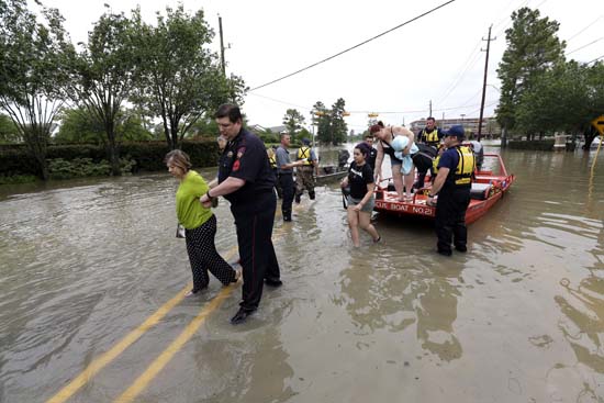 <div class='meta'><div class='origin-logo' data-origin='AP'></div><span class='caption-text' data-credit='AP Photo/David J. Phillip'>Residents are helped off rescue boats after being evacuated from their flooded apartment complex Tuesday, April 19, 2016</span></div>