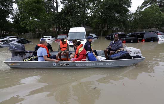 <div class='meta'><div class='origin-logo' data-origin='AP'></div><span class='caption-text' data-credit='AP Photo/David J. Phillip'>Residents are evacuated from their flooded apartment complex Tuesday, April 19, 2016</span></div>