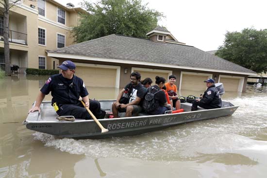 <div class='meta'><div class='origin-logo' data-origin='AP'></div><span class='caption-text' data-credit='AP Photo/David J. Phillip'>Residents are evacuated from their flooded apartment complex Tuesday, April 19, 2016.</span></div>