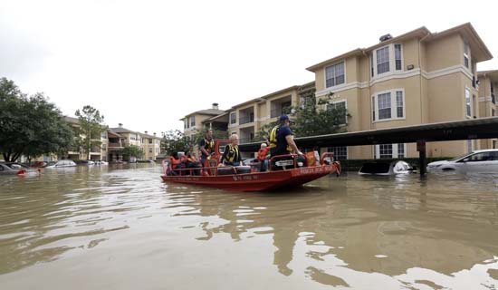 <div class='meta'><div class='origin-logo' data-origin='AP'></div><span class='caption-text' data-credit='AP Photo/David J. Phillip'>Residents are evacuated from their flooded apartment complex Tuesday, April 19, 2016</span></div>