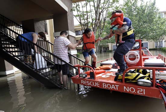 <div class='meta'><div class='origin-logo' data-origin='AP'></div><span class='caption-text' data-credit='AP Photo/David J. Phillip'>Residents are evacuated from their flooded apartment complex</span></div>