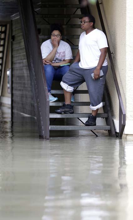 <div class='meta'><div class='origin-logo' data-origin='AP'></div><span class='caption-text' data-credit='AP Photo/David J. Phillip'>Deidra Andrews, left, waits with her husband Robert Darensburg to be evacuated from their flooded apartment complex</span></div>