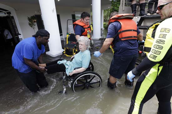 <div class='meta'><div class='origin-logo' data-origin='AP'></div><span class='caption-text' data-credit='AP Photo/David J. Phillip'>A resident of a retirement and assisted living complex is helped by rescue personnel as the facility is evacuated due to rising floodwaters</span></div>