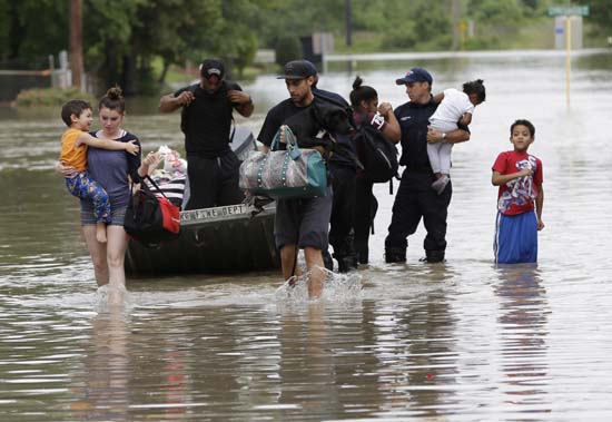 <div class='meta'><div class='origin-logo' data-origin='AP'></div><span class='caption-text' data-credit='AP Photo/David J. Phillip'>Residents walk through floodwaters after being evacuated from their flooded apartment complex</span></div>