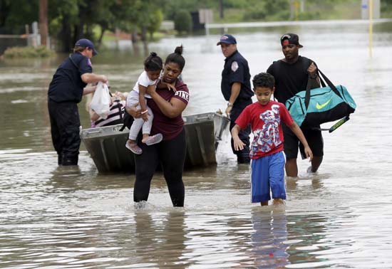 <div class='meta'><div class='origin-logo' data-origin='AP'></div><span class='caption-text' data-credit='AP Photo/David J. Phillip'>Residents walk through floodwaters after being evacuated from their flooded apartment complex</span></div>