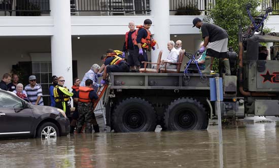 <div class='meta'><div class='origin-logo' data-origin='AP'></div><span class='caption-text' data-credit='AP Photo/David J. Phillip'>Residents are evacuated from a retirement and assisted living complex as floodwaters rise</span></div>