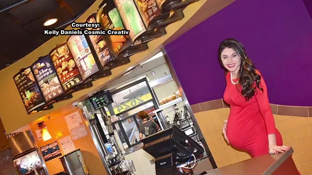 Woman shows off baby bump outside Taco Bell restaurant
