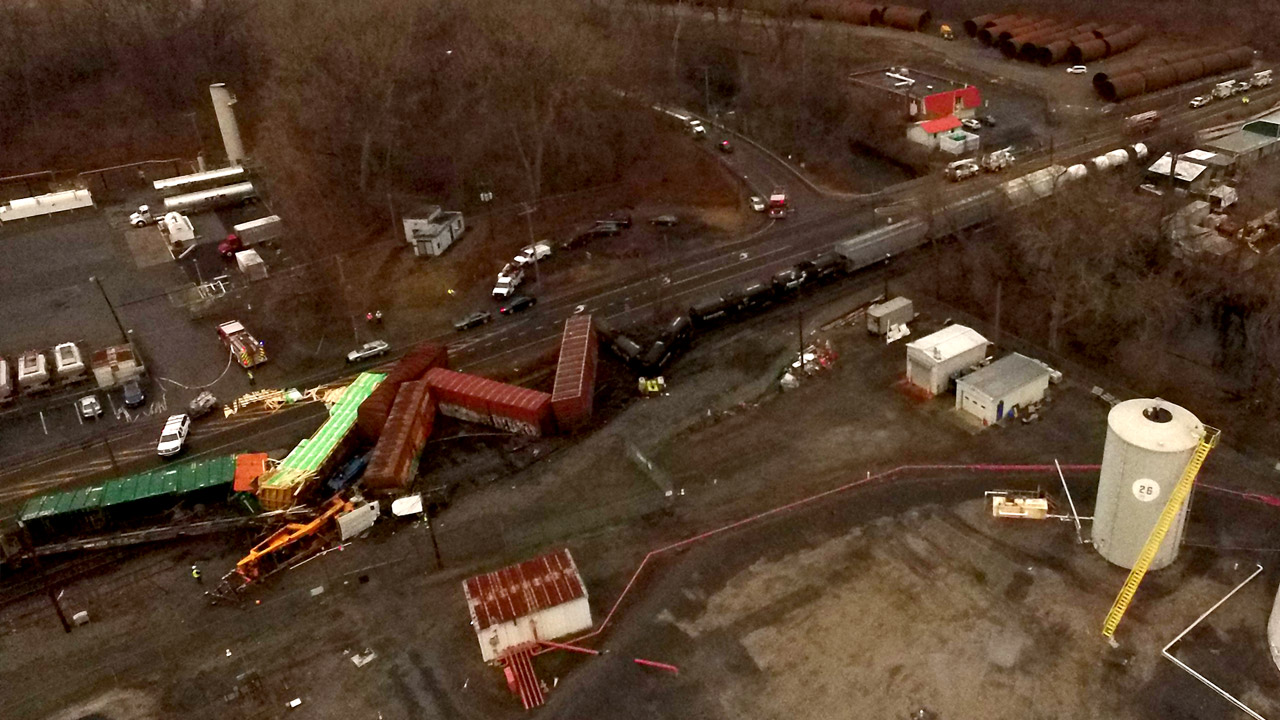 Crews removing derailed freight train with hazardous load Crews removing derailed freight train with hazardous load
