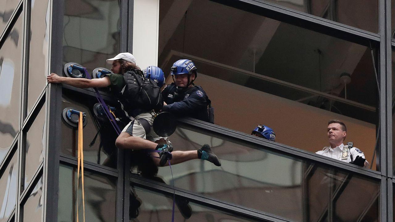 Man climbing Trump Tower in New York City with suction cups captured