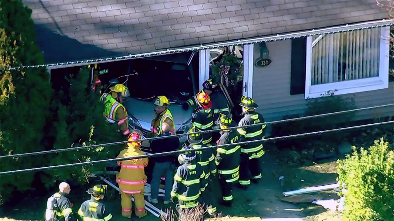 Car crashes into home in Washington Township