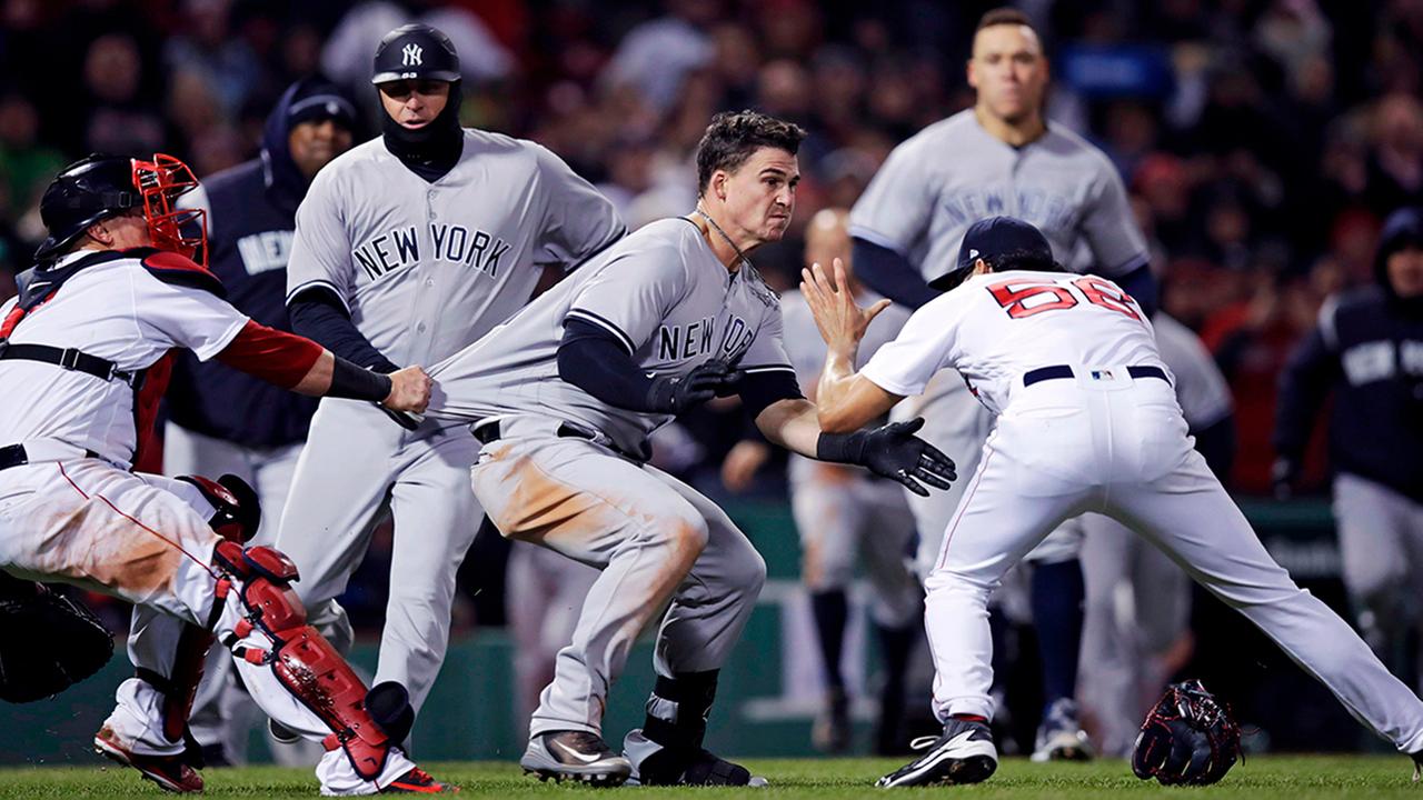 New York Yankees Tyler Austin, center, rushes Boston Red Sox relief pitcher Joe Kelly, right, after being hit by a pitch during the seventh inning.  (AP Photo/Charles Krupa)