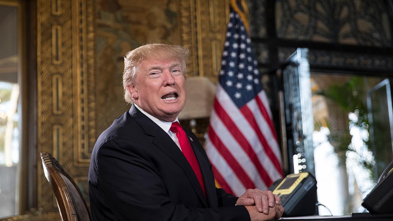 President Trump turns to talk to the gathered media during a Christmas Eve video teleconference with members of the mIlitary at his Mar-a-Lago estate.. (AP Photo/Carolyn Kaster)