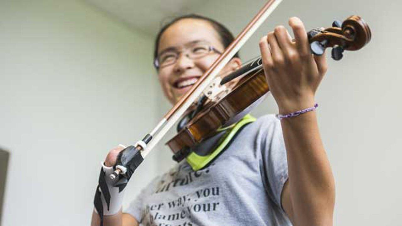 NIU student designs prosthetic for aspiring violinist born ...