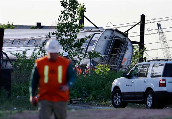 <div class='meta'><div class='origin-logo' data-origin='AP'></div><span class='caption-text' data-credit='AP Photo/Mel Evans'>Emergency personnel gather near the scene of a deadly train derailment, Wednesday, May 13, 2015, in Philadelphia.</span></div>