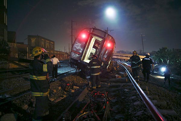 <div class='meta'><div class='origin-logo' data-origin='AP'></div><span class='caption-text' data-credit='AP Photo/ Joseph Kaczmarek'>Emergency personnel work the scene of a deadly train wreck, Tuesday, May 12, 2015, in Philadelphia.</span></div>