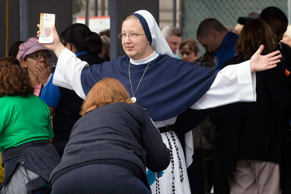 <div class='meta'><div class='origin-logo' data-origin='~ORIGIN~'></div><span class='caption-text' data-credit='Photo/John Minchillo'>A nun from The Sisters of Life, of New York City, is inspected at a security checkpoint as she arrives for a Mass.</span></div>