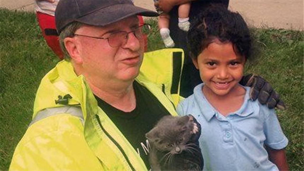 In this May 26, 2015 photo, Lancaster Township Fire Department Deputy Fire Chief Glenn Usdin, left, holds the kitten that was rescued with the help of ... - 758682_1280x720