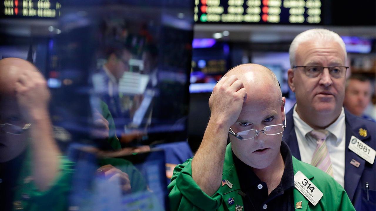 Trader Kevin Walsh, second from right, works on the floor of the New York Stock Exchange, Friday, June 24, 2016.