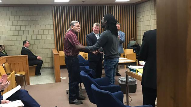 John McGraw and Rakeem Jones shake hands in a Fayetteville courtroom