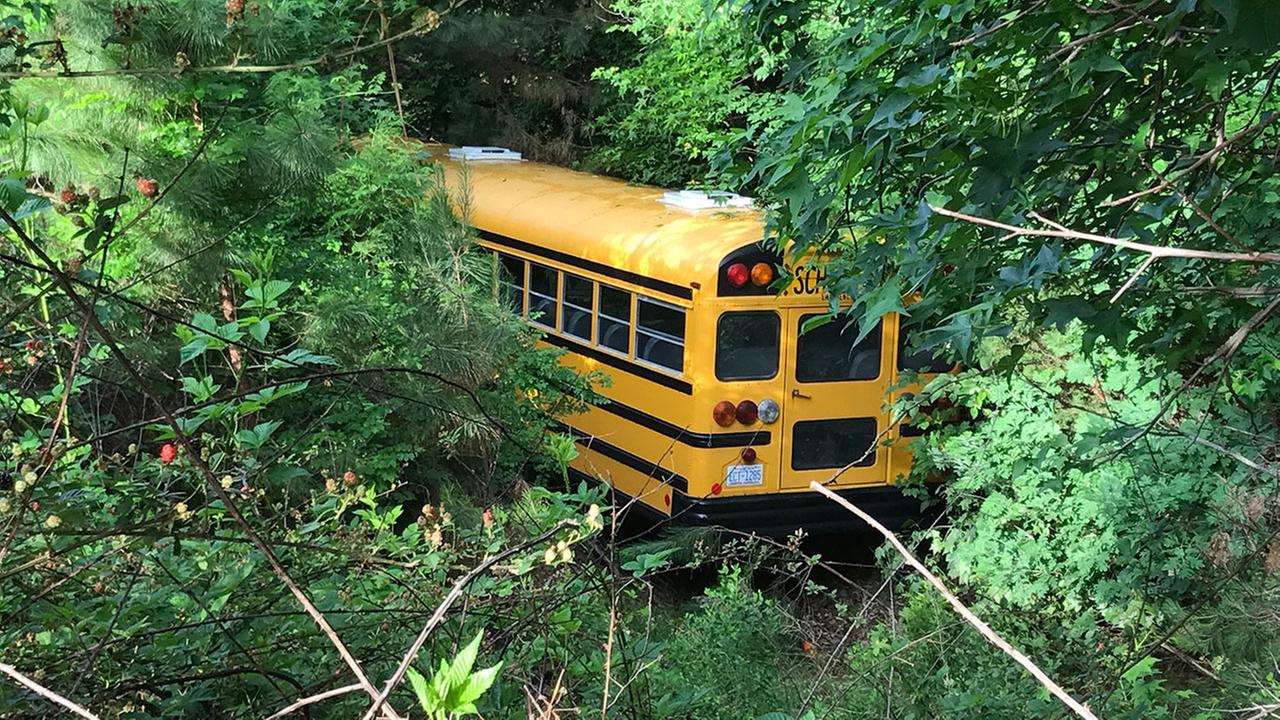 Private school bus runs off road, into woods in Cary
