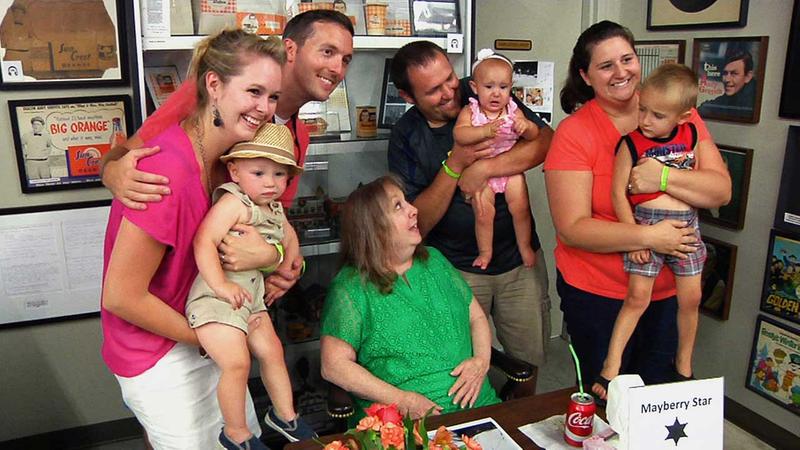 Actress Betty Lynn looks up at a crying baby during a photo opportunity at the Andy Griffith Museum in Mount Airy, N.C.