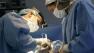 Plastic surgeon Dr. Isaias Bello, left, performs breast implant surgery in Caracas, Venezuela, Sept. 21, 2005.