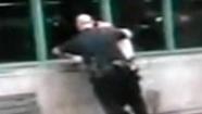 Officer pushes suspect through glass window