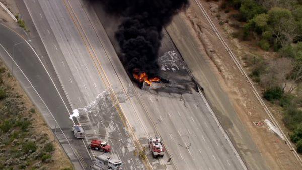 A tanker truck overturned and exploded on the 91 Freeway in Corona on Friday, shooting flames over 100 feet in the air.