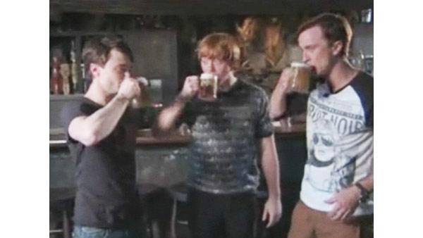 Daniel Radcliffe (Harry Potter), Rupert Grint (Ron Weasley) and Tom Felton (Draco Malfoy) toast butterbeers at 'The Wizarding World of Harry Potter,' which opened at Universal Studios in Orlando, Florida on June 18, 2010.
