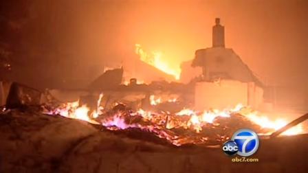 Homes are being destroyed as a massive fire roars through a residential neighborhood in a south San Francisco suburb.