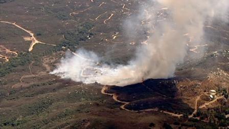 Fire crews are battling a brush fire in the Cleveland National Forest near the Orange-Riverside county line.