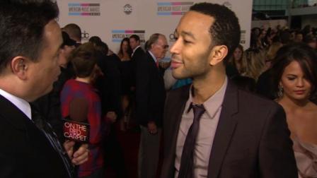John Legend speaks on the red carpet at the 2010 American Music Awards in Los Angeles.