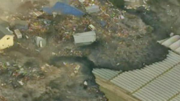Aerial footage in Japan shows a tsunami wave washing away everything in its path following a huge earthquake.
