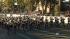 A marching band passes the crowd on Orange Grove...