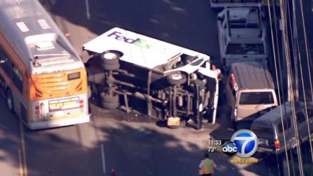 A Metro bus collided with a FedEx truck in Panorama City Wednesday morning, knocking the truck over and spilling fuel.