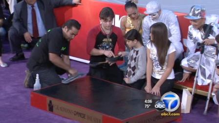 Michael Jacksons children are seen helping immortalize their fathers footprints in Hollywood Thursday, Jan. 26, 2012.