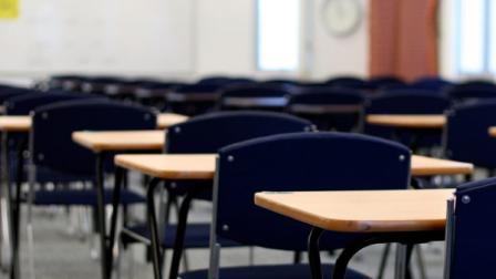 Desks in a classroom are shown in this undated file photo.
