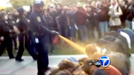 A UC Davis campus police officer is seen pepper-spraying demonstrators in Nov. 2011.