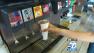 A person is seen filling a cup with soda at a soda machine in this undated file photo.