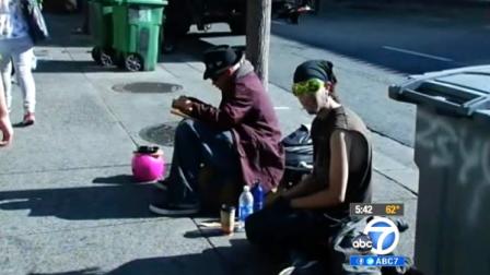 Two men are seen sitting on a sidewalk in Berkeley, Calif., in this undated file photo. Mayor Tom Bates hopes to get an initiative on the November ballot that would ban people from sitting on city sidewalks during certain times of the day.