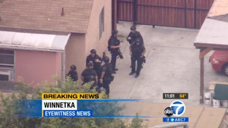 A SWAT team is seen surrounding the home of a barricade suspect in Winnetka Monday, June 4, 2012.